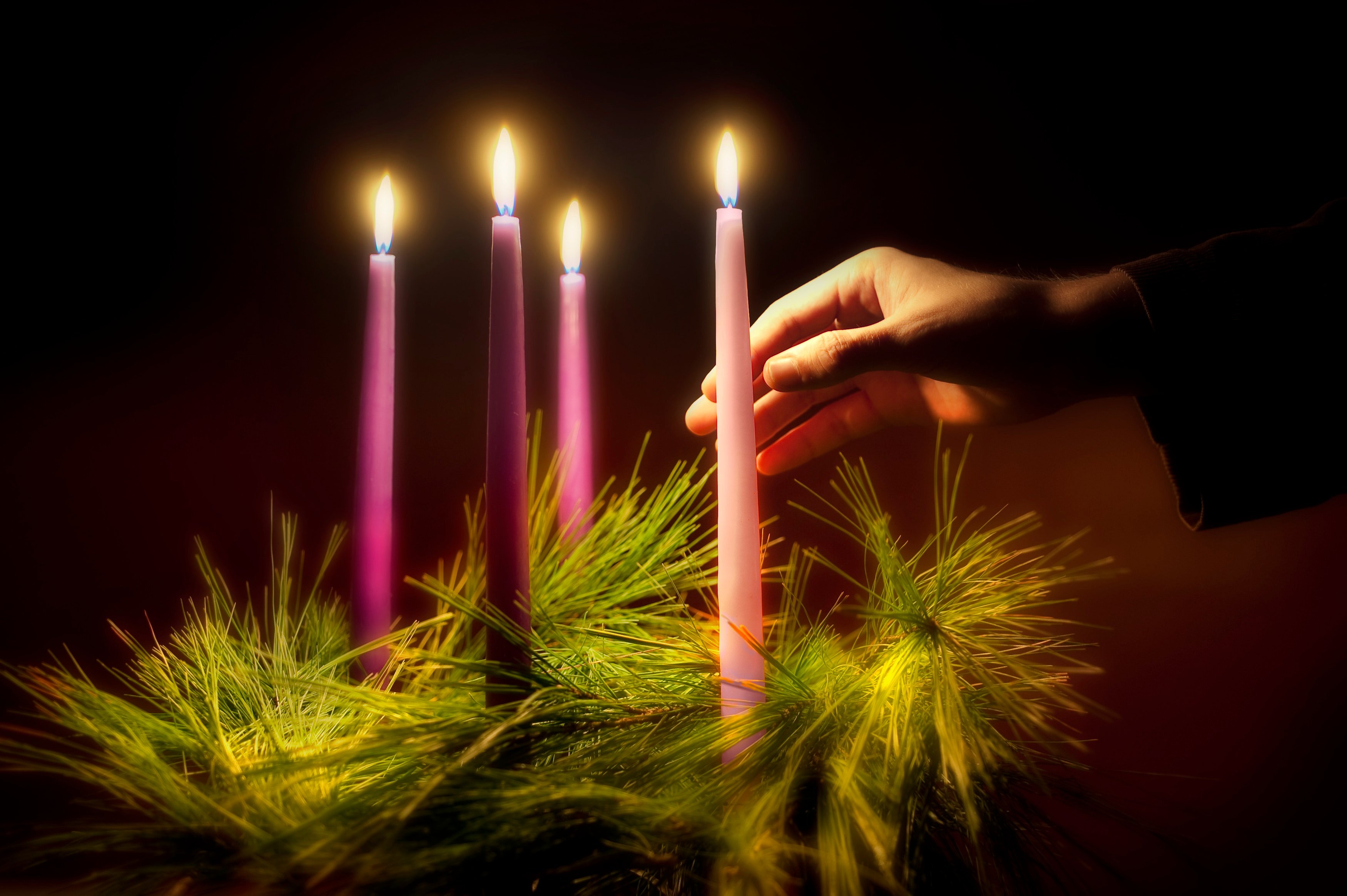 Advent candles lit and hand holding